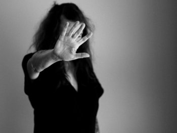 woman covering her face with her hand